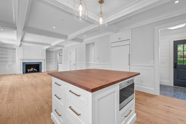 287 Cedar St, Chatham, MA 02633 - kitchen with wooden counters, built in appliances, light wood-style floors, beam ceiling, and white cabinetry