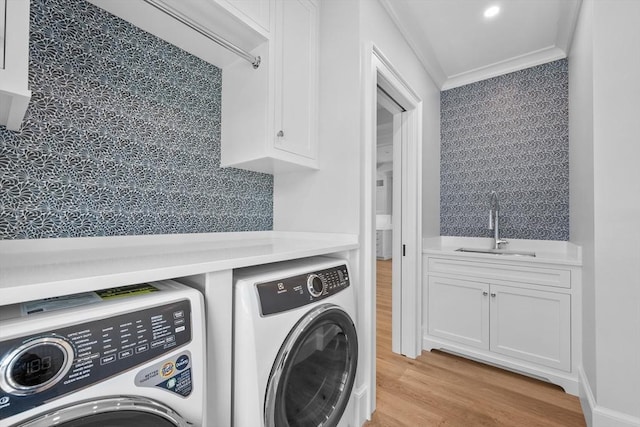 287 Cedar St, Chatham, MA 02633 - washroom with independent washer and dryer, crown molding, light wood-style floors, and cabinet space