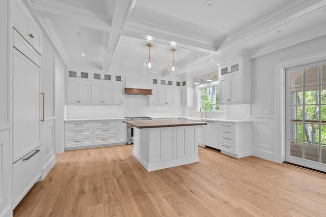 287 Cedar St, Chatham, MA 02633 - kitchen with stainless steel range oven, light wood-type flooring, white cabinets, butcher block countertops, and coffered ceiling
