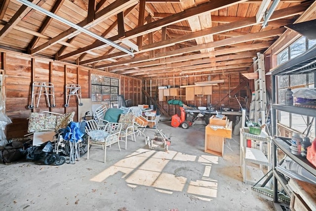 misc room with a garage and lofted ceiling