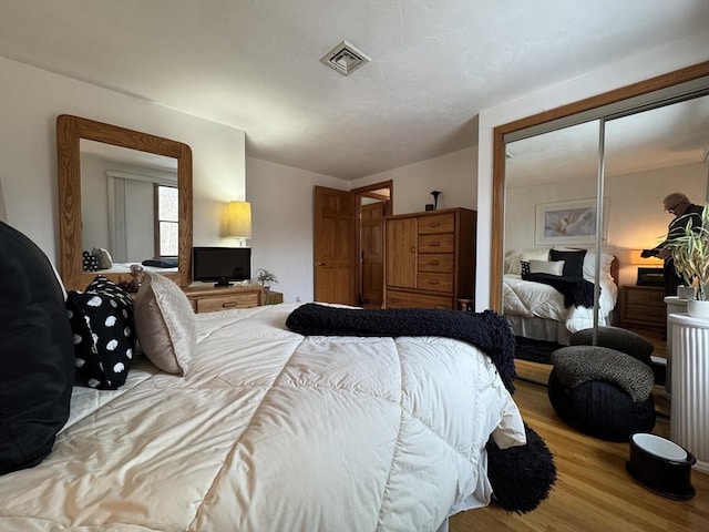 bedroom with a closet and light wood-type flooring