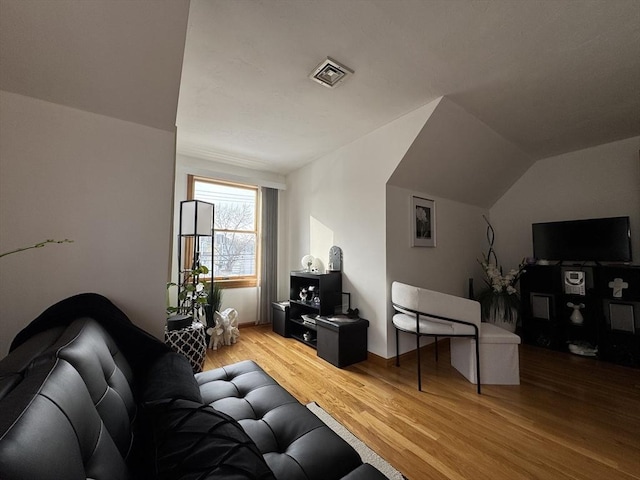 living room with lofted ceiling and wood-type flooring