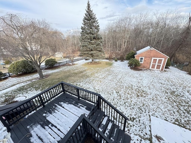 snow covered deck with a storage unit