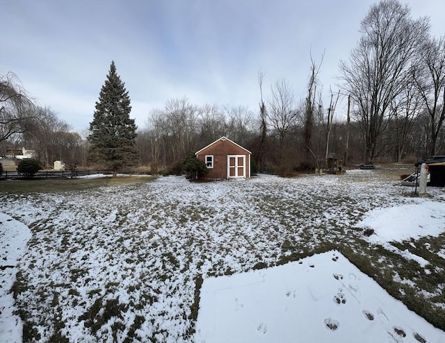 yard covered in snow featuring a storage unit