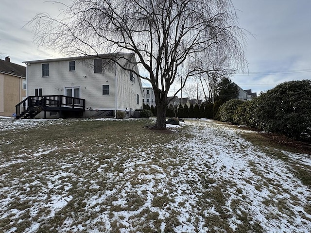 snowy yard featuring a deck