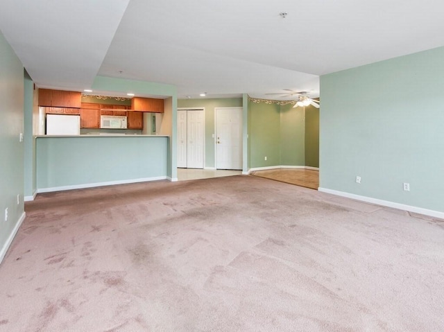 218 Reservoir St Unit 211, Holden, MA 01520 - unfurnished living room featuring baseboards, carpet flooring, a ceiling fan, and recessed lighting