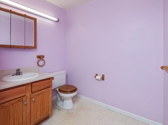 218 Reservoir St Unit 211, Holden, MA 01520 - bathroom featuring toilet, vanity, baseboards, and tile patterned floors