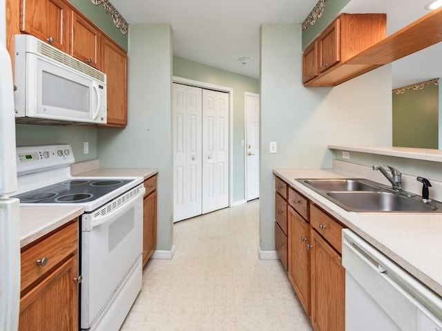 218 Reservoir St Unit 211, Holden, MA 01520 - kitchen with white appliances, a sink, light floors, light countertops, and brown cabinets