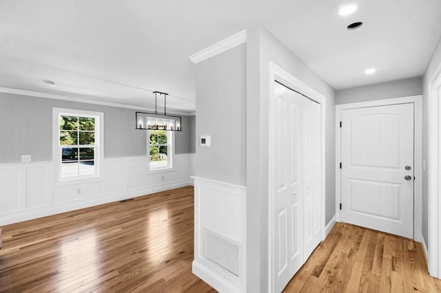 312 Old Westport, Dartmouth, MA 02747 - hallway featuring a wainscoted wall, light wood finished floors, crown molding, and a chandelier