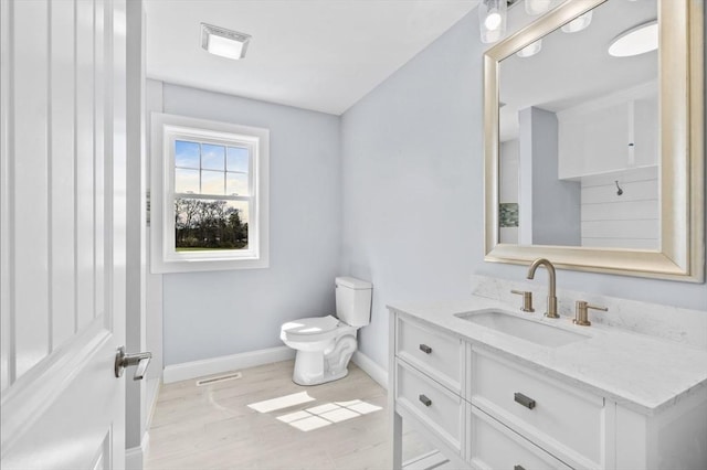 312 Old Westport, Dartmouth, MA 02747 - bathroom featuring vanity, baseboards, toilet, and wood finished floors