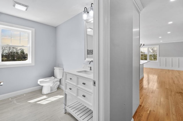 312 Old Westport, Dartmouth, MA 02747 - bathroom featuring wood finished floors, vanity, toilet, a chandelier, and baseboards