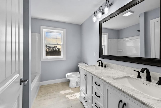 312 Old Westport, Dartmouth, MA 02747 - bathroom with double vanity, toilet, baseboards, wood finished floors, and tub / shower combination