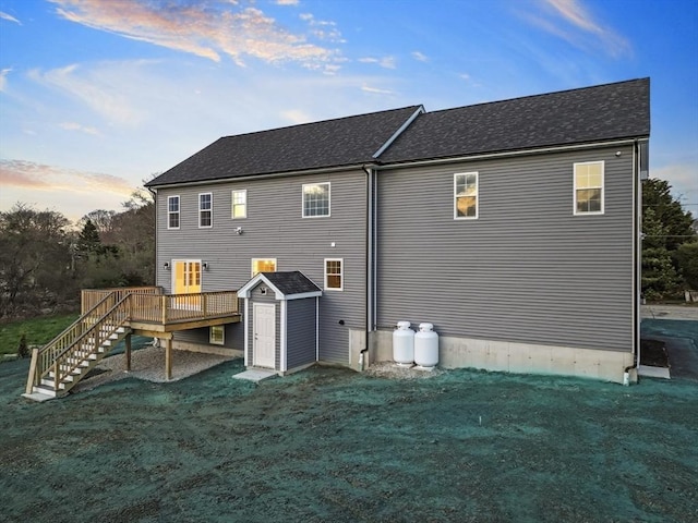 312 Old Westport, Dartmouth, MA 02747 - back of property at dusk featuring stairway, a deck, a shed, and a lawn