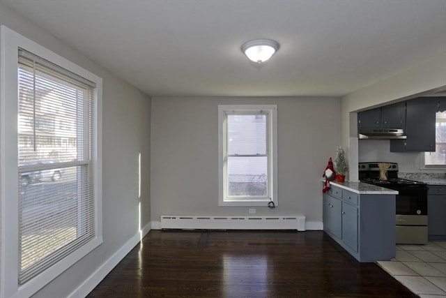 kitchen featuring a healthy amount of sunlight, dark hardwood / wood-style floors, a baseboard heating unit, and stainless steel range with electric cooktop