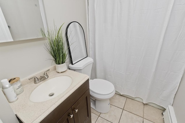 bathroom featuring toilet, vanity, tile patterned floors, and a baseboard heating unit