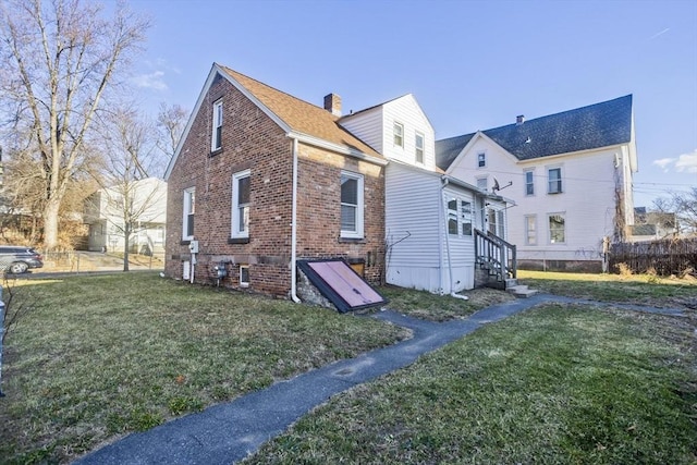 rear view of property featuring a yard