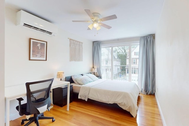 10 Bradbury St Unit 10, Boston, MA 02134 - bedroom featuring an AC wall unit, light wood-type flooring, a desk, baseboards, and ceiling fan