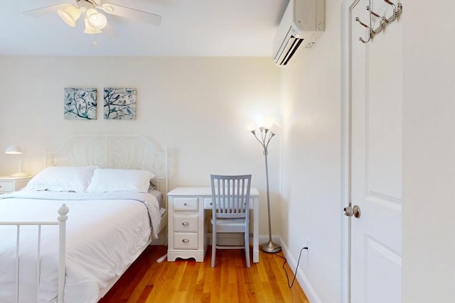 10 Bradbury St Unit 10, Boston, MA 02134 - bedroom featuring an AC wall unit, light wood-style flooring, and a ceiling fan