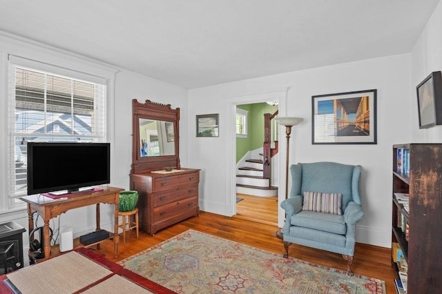 52 Locust St, Lynn, MA 01904 - living area with wood finished floors, a healthy amount of sunlight, and stairway