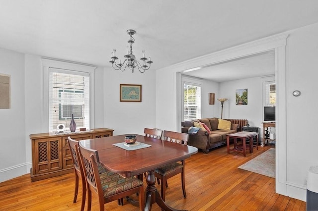 52 Locust St, Lynn, MA 01904 - dining area featuring baseboards, light wood finished floors, and a notable chandelier