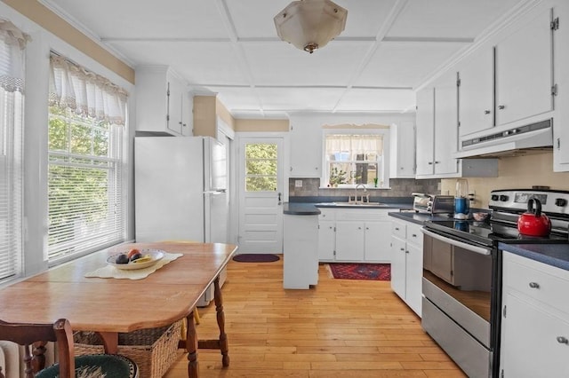 52 Locust St, Lynn, MA 01904 - kitchen with freestanding refrigerator, dark countertops, under cabinet range hood, electric stove, and light wood finished floors