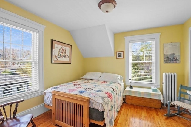 52 Locust St, Lynn, MA 01904 - bedroom with baseboards, radiator heating unit, vaulted ceiling, and hardwood / wood-style floors