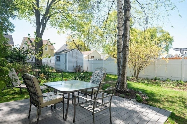 52 Locust St, Lynn, MA 01904 - wooden deck featuring a storage unit, outdoor dining space, a fenced backyard, an outdoor structure, and a yard