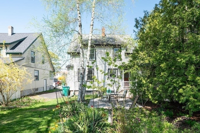 52 Locust St, Lynn, MA 01904 - back of house with a patio, a chimney, and a yard