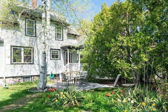 52 Locust St, Lynn, MA 01904 - rear view of house with a chimney and a patio area