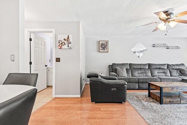 living room with ceiling fan and hardwood / wood-style floors