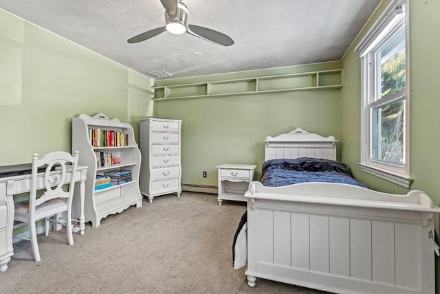 bedroom with a baseboard radiator, ceiling fan, and carpet