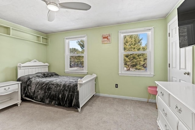 bedroom featuring light carpet and ceiling fan