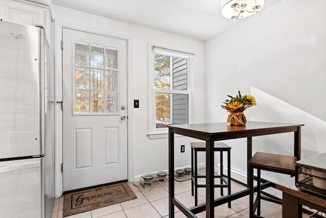 doorway to outside featuring light tile patterned floors