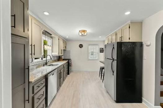 1029 Joyce St, New Bedford, MA 02745 - kitchen with appliances with stainless steel finishes, a sink, baseboards, light wood-style floors, and recessed lighting
