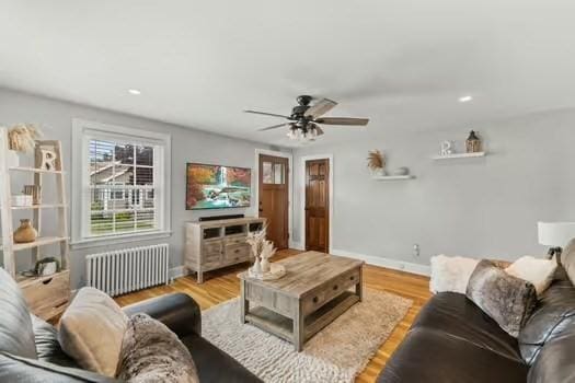 1029 Joyce St, New Bedford, MA 02745 - living room with radiator heating unit, a ceiling fan, baseboards, light wood-type flooring, and recessed lighting