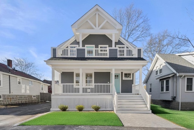 view of front of home featuring covered porch and a front yard