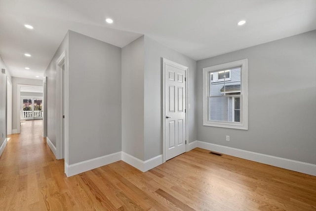 corridor with light hardwood / wood-style floors