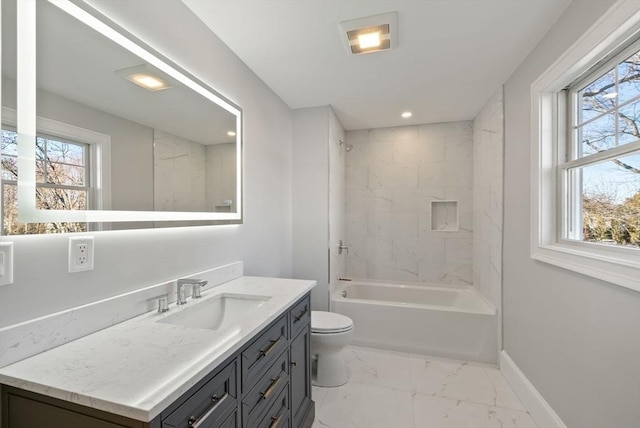 full bathroom featuring toilet, vanity, and tiled shower / bath