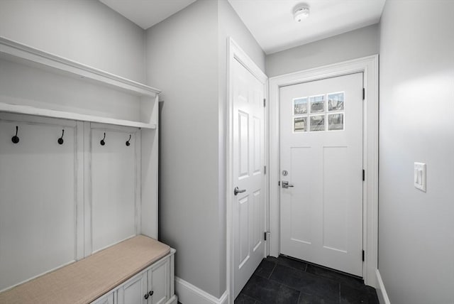 mudroom featuring dark tile patterned floors