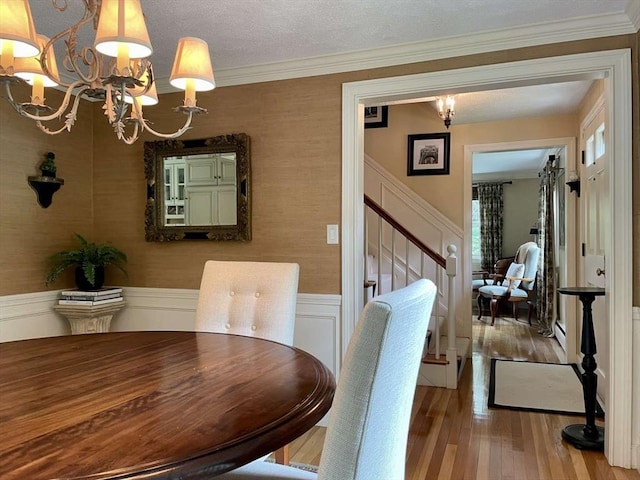 4 Hickory Ln, North Reading, MA 01864 - dining area featuring a chandelier, wood finished floors, stairs, ornamental molding, and a wainscoted wall