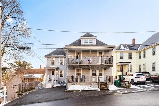 view of front of property with a balcony and covered porch