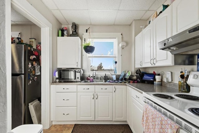 kitchen with extractor fan, sink, a paneled ceiling, appliances with stainless steel finishes, and white cabinets