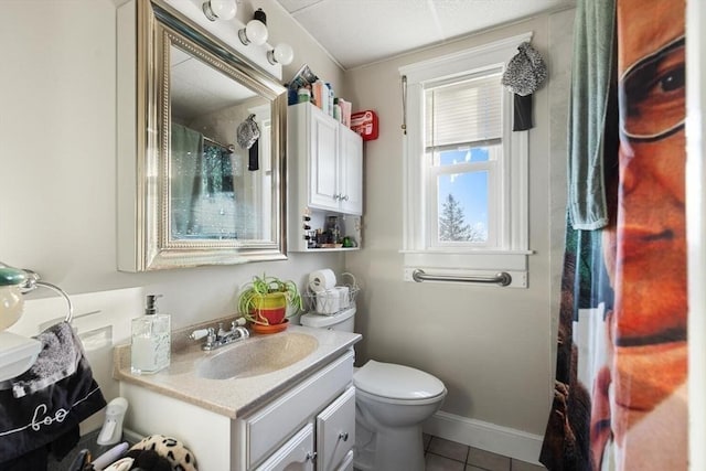 bathroom featuring vanity, tile patterned floors, and toilet