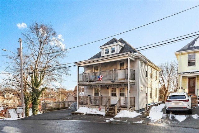 view of front of property with a balcony and covered porch