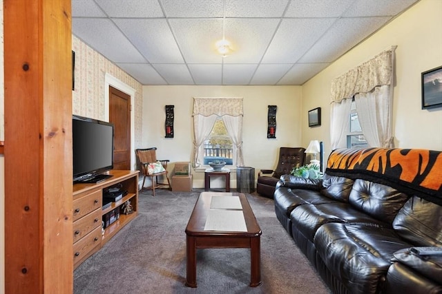 carpeted living room featuring plenty of natural light and a drop ceiling