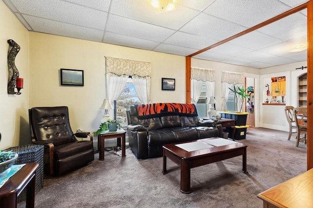 carpeted living room with a paneled ceiling