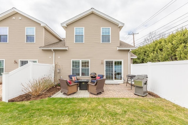 rear view of house featuring outdoor lounge area, a patio, a fenced backyard, a shingled roof, and a lawn