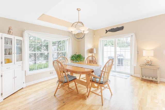 dining area with an inviting chandelier, baseboards, light wood-style floors, and a wealth of natural light