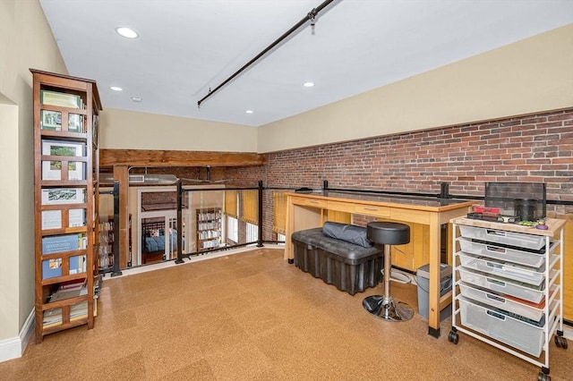 interior space featuring recessed lighting, baseboards, and brick wall