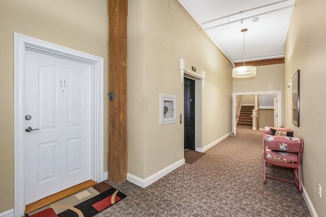 hallway with carpet flooring and baseboards